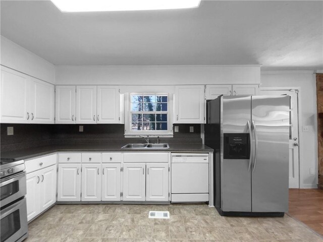 8005 Bamby Ln, Jonesboro, GA 30236 - kitchen with dark countertops, double oven range, white dishwasher, and stainless steel fridge with ice dispenser