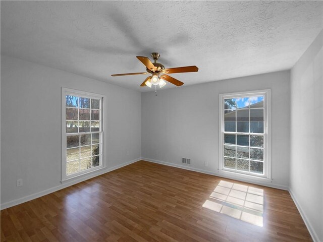 8005 Bamby Ln, Jonesboro, GA 30236 - empty room featuring baseboards, a textured ceiling, visible vents, and wood finished floors