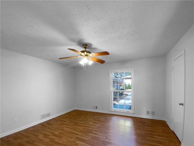 8005 Bamby Ln, Jonesboro, GA 30236 - spare room featuring a ceiling fan, visible vents, a textured ceiling, and wood finished floors
