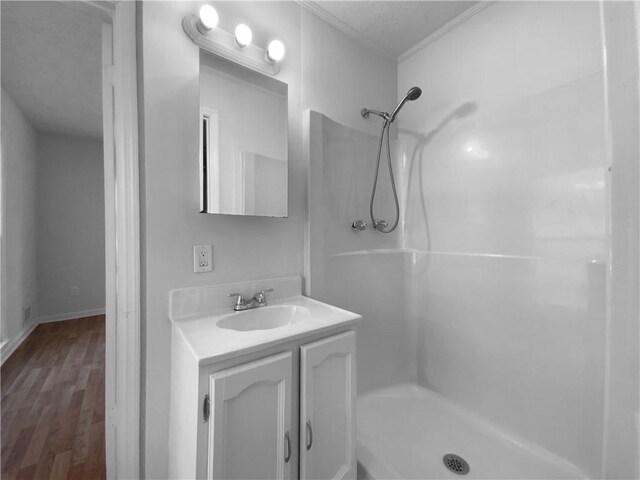 8005 Bamby Ln, Jonesboro, GA 30236 - bathroom with wood finished floors, a shower stall, and vanity