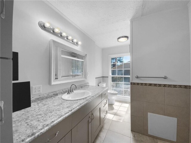 8005 Bamby Ln, Jonesboro, GA 30236 - full bathroom with a textured ceiling, toilet, vanity, tile walls, and tile patterned floors