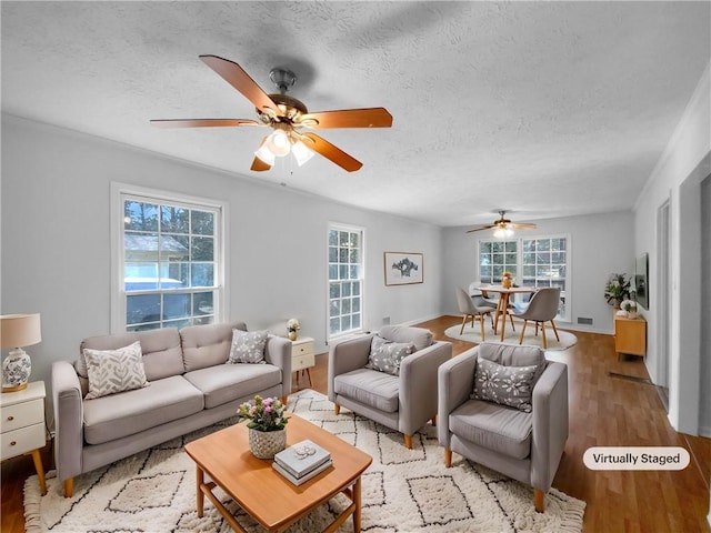 8005 Bamby Ln, Jonesboro, GA 30236 - living area with a ceiling fan, visible vents, a textured ceiling, and wood finished floors