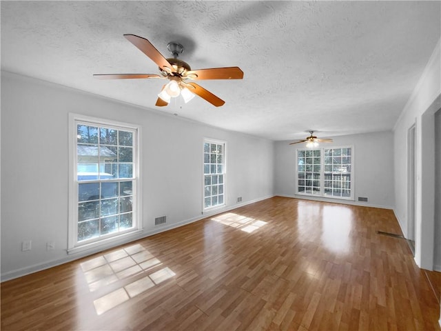 8005 Bamby Ln, Jonesboro, GA 30236 - unfurnished room featuring visible vents, a textured ceiling, and wood finished floors