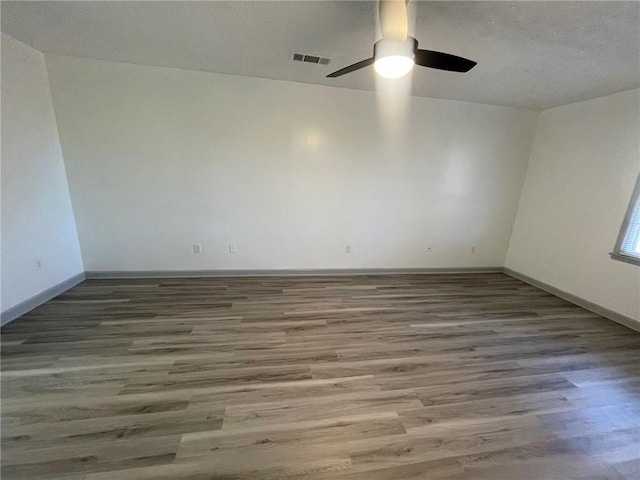 unfurnished room featuring ceiling fan and wood-type flooring