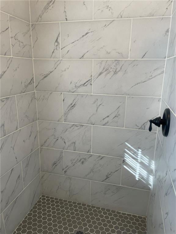 bathroom with tiled shower