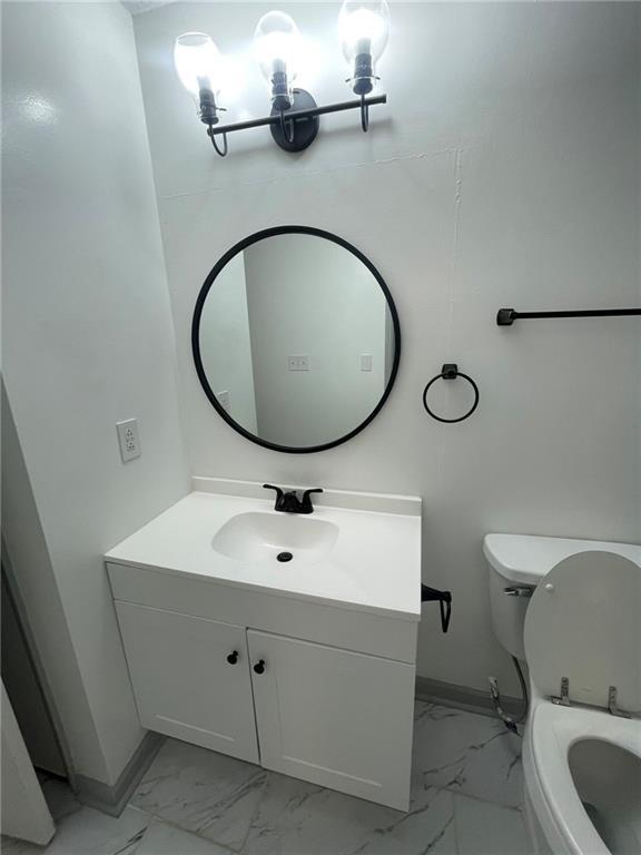 bathroom featuring toilet and vanity