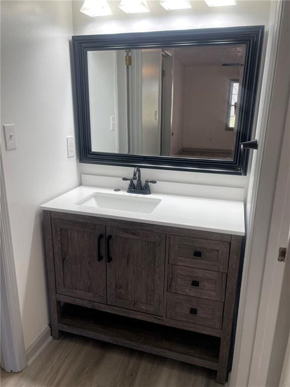 bathroom featuring hardwood / wood-style floors and vanity