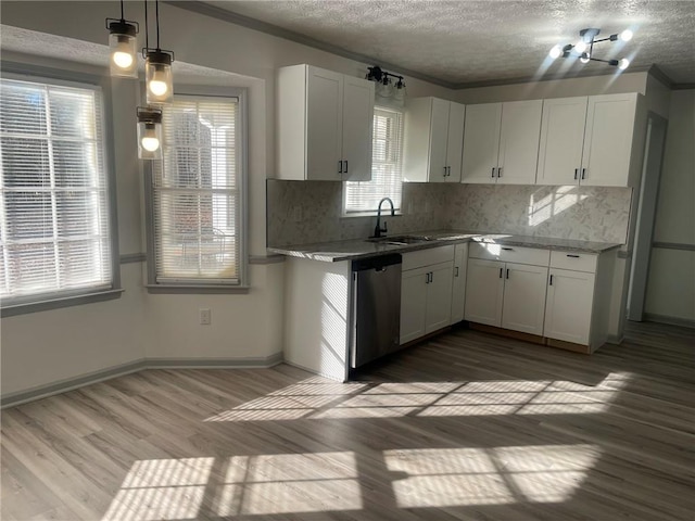 kitchen featuring decorative light fixtures, stainless steel dishwasher, hardwood / wood-style flooring, a textured ceiling, and white cabinets