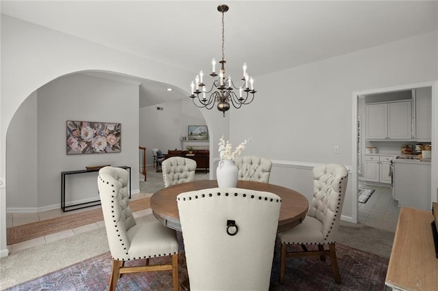1050 Shady Valley Pl, Atlanta, GA 30324 - dining area with arched walkways, a chandelier, tile patterned flooring, and carpet floors