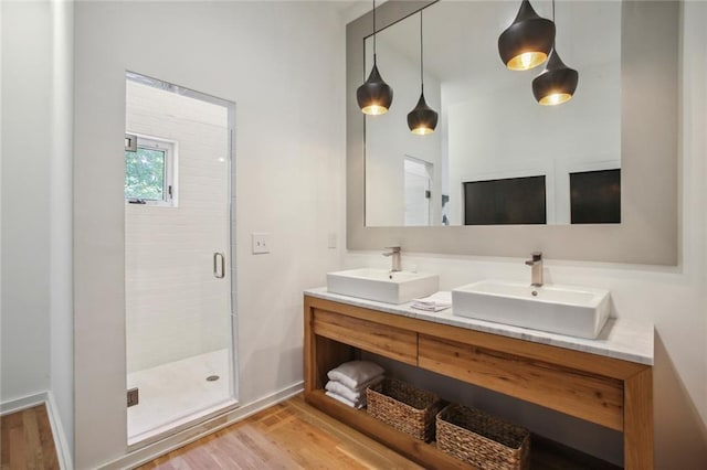 bathroom with vanity, hardwood / wood-style floors, and walk in shower