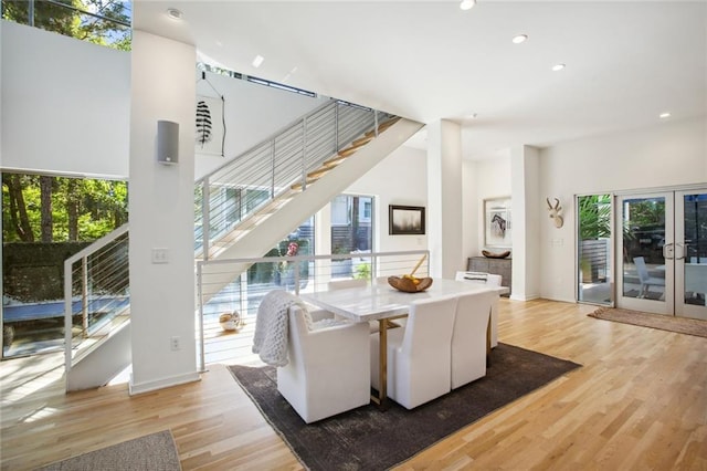 dining area with light hardwood / wood-style floors and french doors