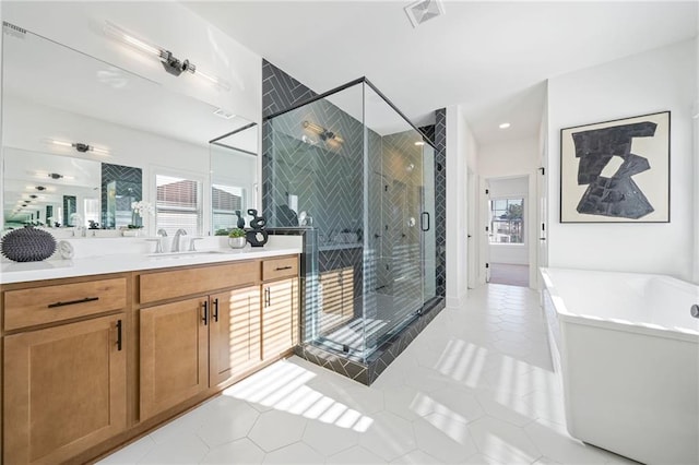 bathroom featuring vanity, tile patterned floors, and separate shower and tub