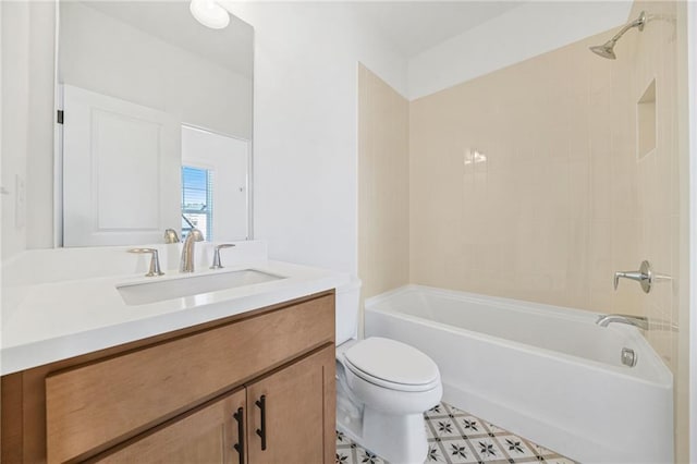 full bathroom with vanity, tiled shower / bath combo, and toilet