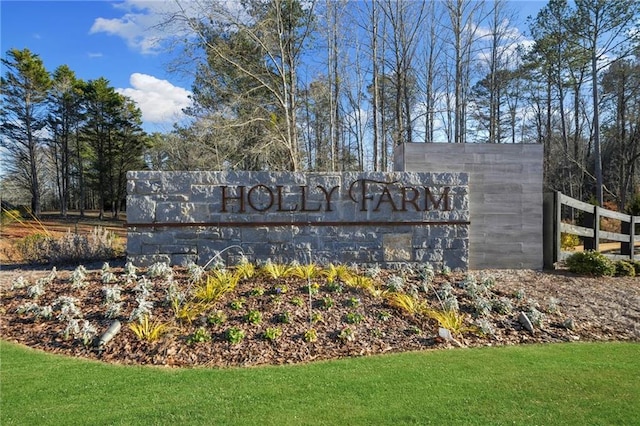 community / neighborhood sign with a lawn