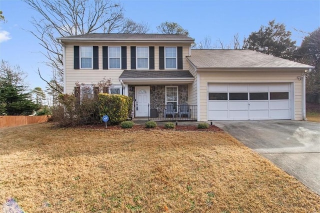 view of front of property featuring a garage, a porch, and a front lawn