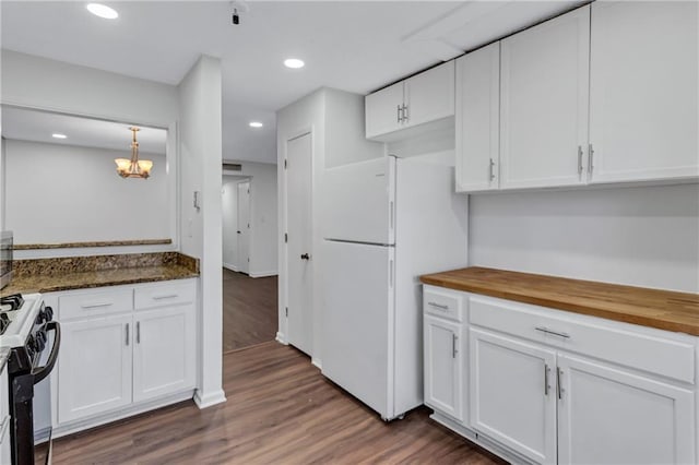 kitchen with white cabinetry, range with gas stovetop, white fridge, and butcher block counters