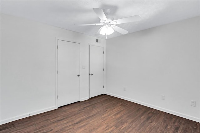 unfurnished bedroom featuring ceiling fan and dark hardwood / wood-style floors