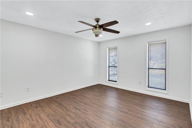 spare room featuring ceiling fan and dark wood-type flooring