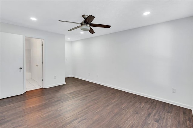 spare room with dark wood-type flooring and ceiling fan