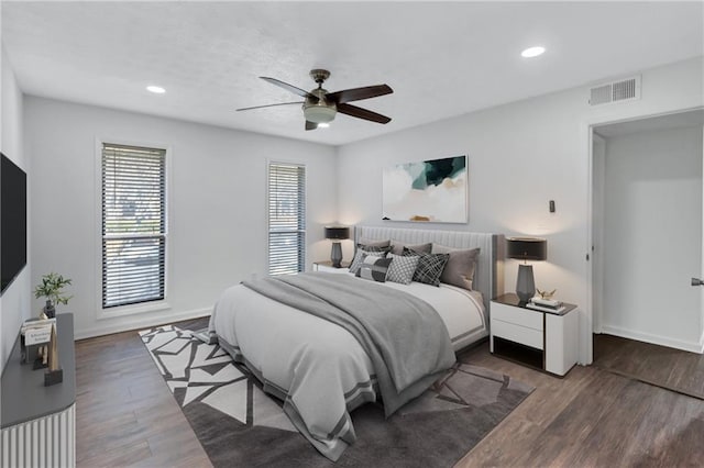 bedroom with ceiling fan and dark hardwood / wood-style floors