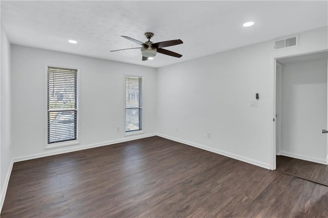 spare room with ceiling fan and dark hardwood / wood-style flooring