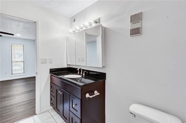 bathroom featuring toilet, tile patterned floors, and vanity