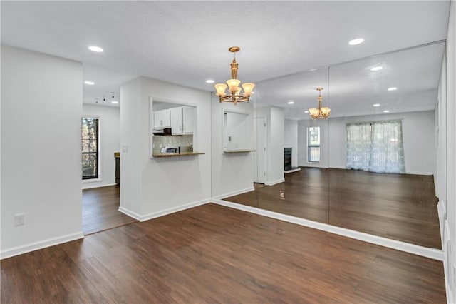 interior space featuring a chandelier and dark hardwood / wood-style floors