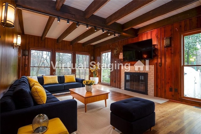 970 Winding Creek Trl, Sandy Springs, GA 30328 - living room with rail lighting, beamed ceiling, plenty of natural light, wood walls, and a brick fireplace