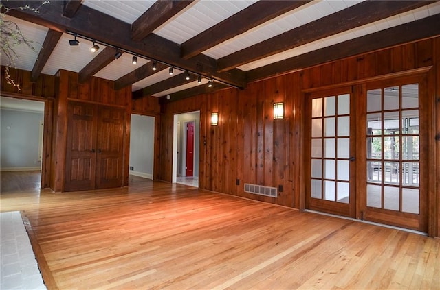 970 Winding Creek Trl, Sandy Springs, GA 30328 - empty room with rail lighting, wooden walls, beam ceiling, and hardwood / wood-style flooring