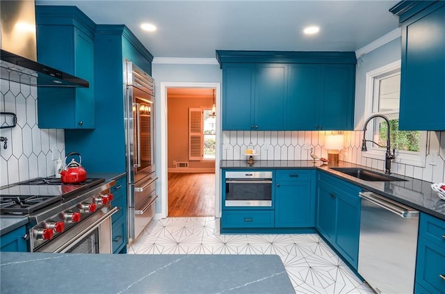 970 Winding Creek Trl, Sandy Springs, GA 30328 - kitchen with high quality appliances, wall chimney range hood, crown molding, healthy amount of natural light, and tasteful backsplash