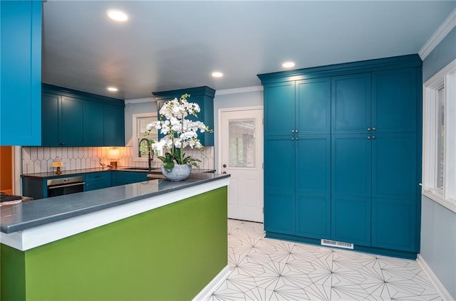 970 Winding Creek Trl, Sandy Springs, GA 30328 - kitchen featuring dark countertops, crown molding, recessed lighting, decorative backsplash, and blue cabinetry