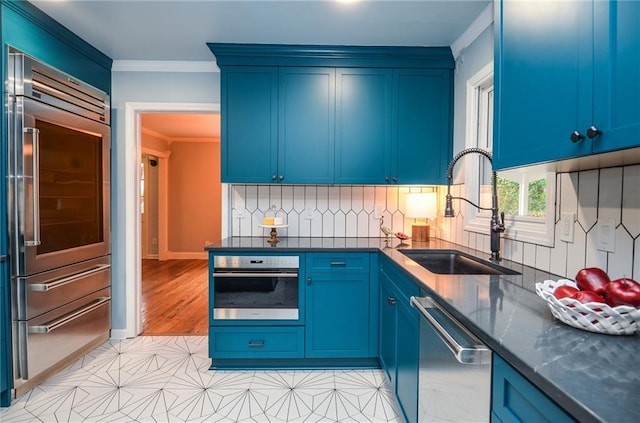970 Winding Creek Trl, Sandy Springs, GA 30328 - kitchen featuring stainless steel appliances, crown molding, tasteful backsplash, blue cabinets, and dark stone countertops