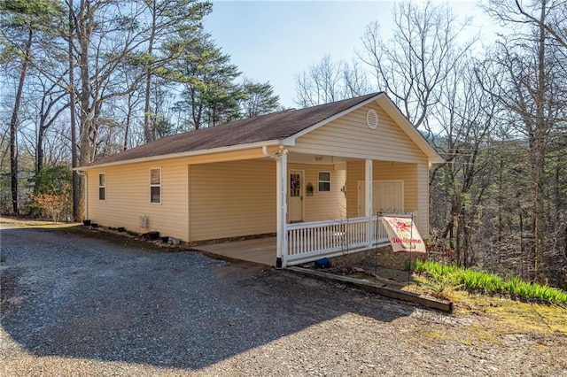 1700 Greenfield Rd, Ellijay, GA 30536 - exterior space with gravel driveway, a carport, and covered porch