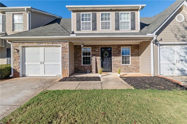 view of front of home featuring a porch, a garage, and a front lawn