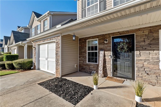 property entrance with covered porch and a garage