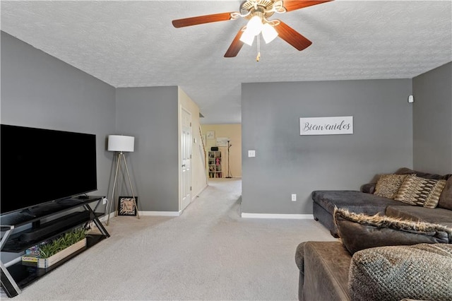 carpeted living room with ceiling fan and a textured ceiling