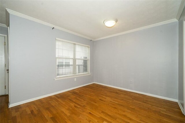 unfurnished room with wood-type flooring and crown molding