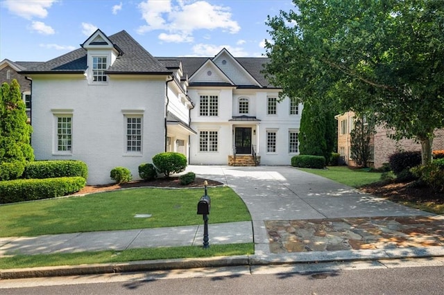 745 Glengate Pl, Atlanta, GA 30328 - french country inspired facade with a front lawn, concrete driveway, and roof with shingles