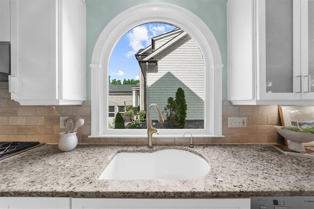 745 Glengate Pl, Atlanta, GA 30328 - kitchen view of white cabinetry, light stone counters, glass insert cabinets, and tasteful backsplash