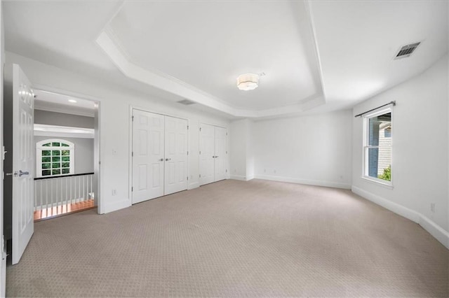 745 Glengate Pl, Atlanta, GA 30328 - unfurnished bedroom featuring a raised ceiling, carpet floors, and multiple closets
