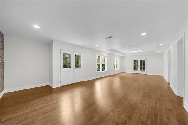 745 Glengate Pl, Atlanta, GA 30328 - unfurnished living room with wood finished floors, recessed lighting, and a tray ceiling