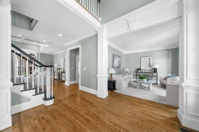 745 Glengate Pl, Atlanta, GA 30328 - foyer entrance with ornate columns, wood finished floors, ornamental molding, stairway, and recessed lighting