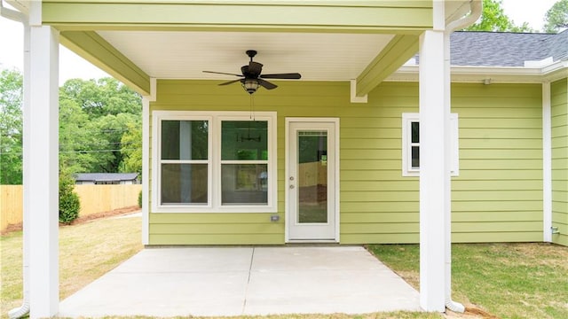 exterior space featuring a patio area, ceiling fan, and a lawn