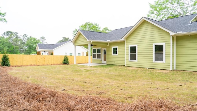 back of house featuring a patio and a yard