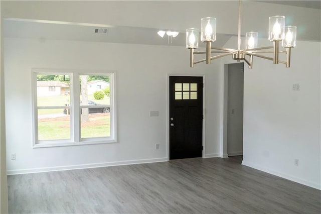 foyer entrance with a notable chandelier and hardwood / wood-style floors