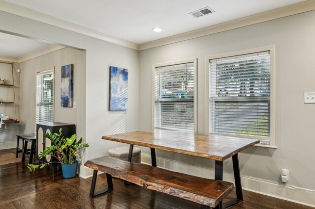 dining area featuring dark hardwood / wood-style flooring and ornamental molding