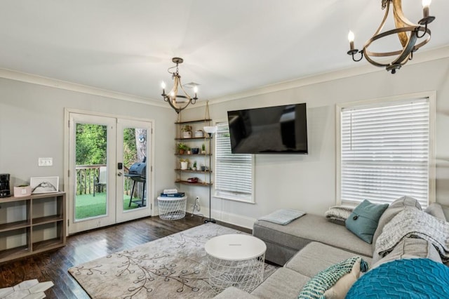 living room with dark wood-type flooring, crown molding, french doors, and a notable chandelier