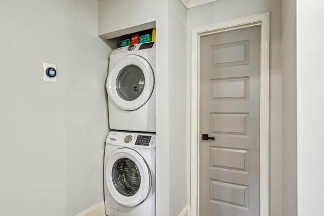 washroom with stacked washer / drying machine