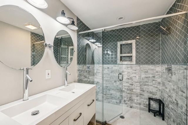 bathroom featuring vanity and a shower with shower door