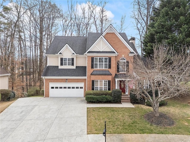 traditional home featuring driveway, roof with shingles, an attached garage, a front lawn, and brick siding